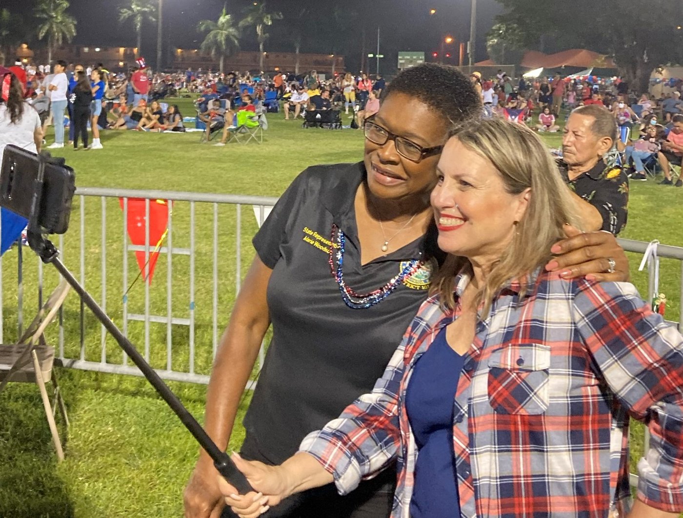 Marie Woodson taking a photo with a resident at a District 105 Fourth of July celebration